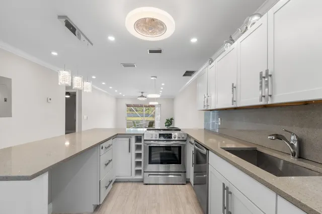 a kitchen with a sink cabinets and window