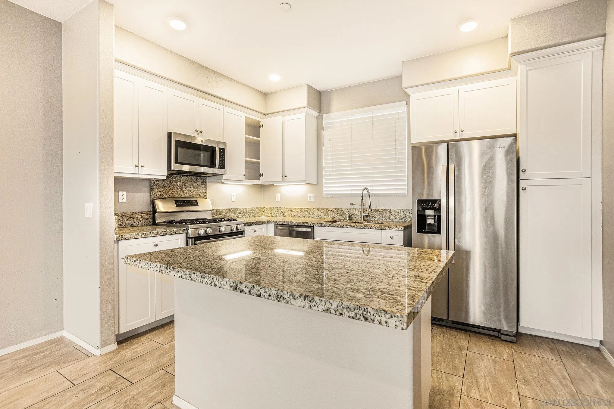 2840 Athens Road, Unit 10 Chula Vista, CA 91915 - Photo 1 of 56 a kitchen with kitchen island a counter top space cabinets and stainless steel appliances