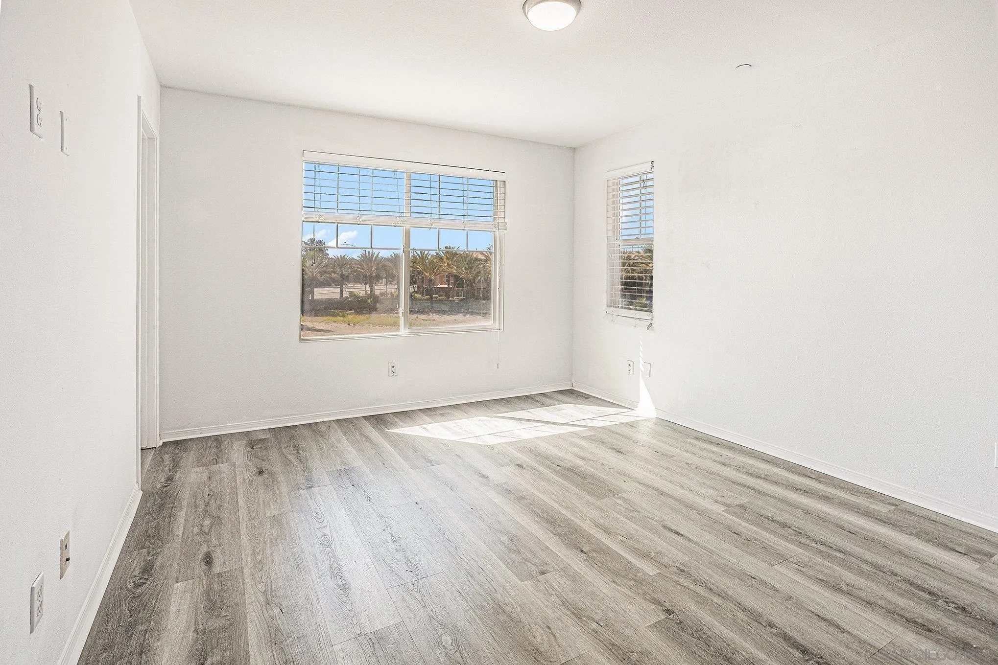 2840 Athens Road, Unit 10 Chula Vista, CA 91915 - Photo 20 of 56 an empty room with wooden floor and windows