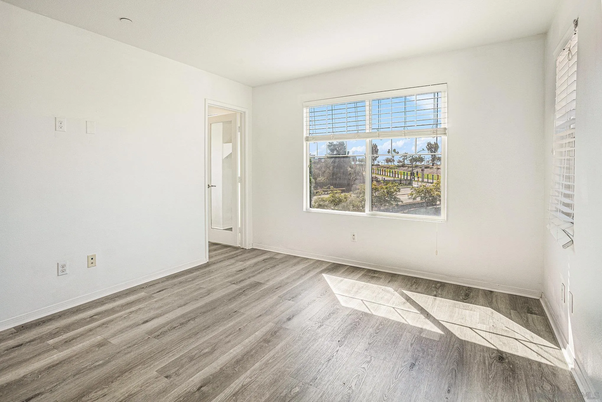 2840 Athens Road, Unit 10 Chula Vista, CA 91915 - Photo 21 of 56 an empty room with wooden floor and windows