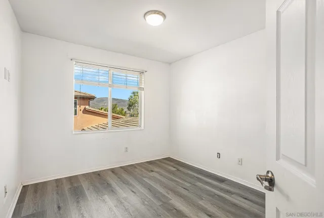 an empty room with wooden floor