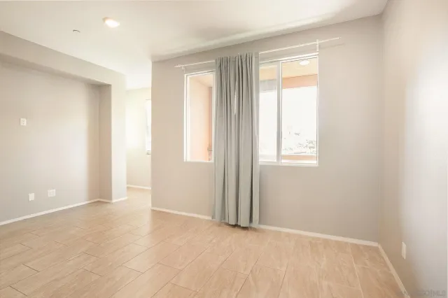 a view of a livingroom with kitchen and furniture