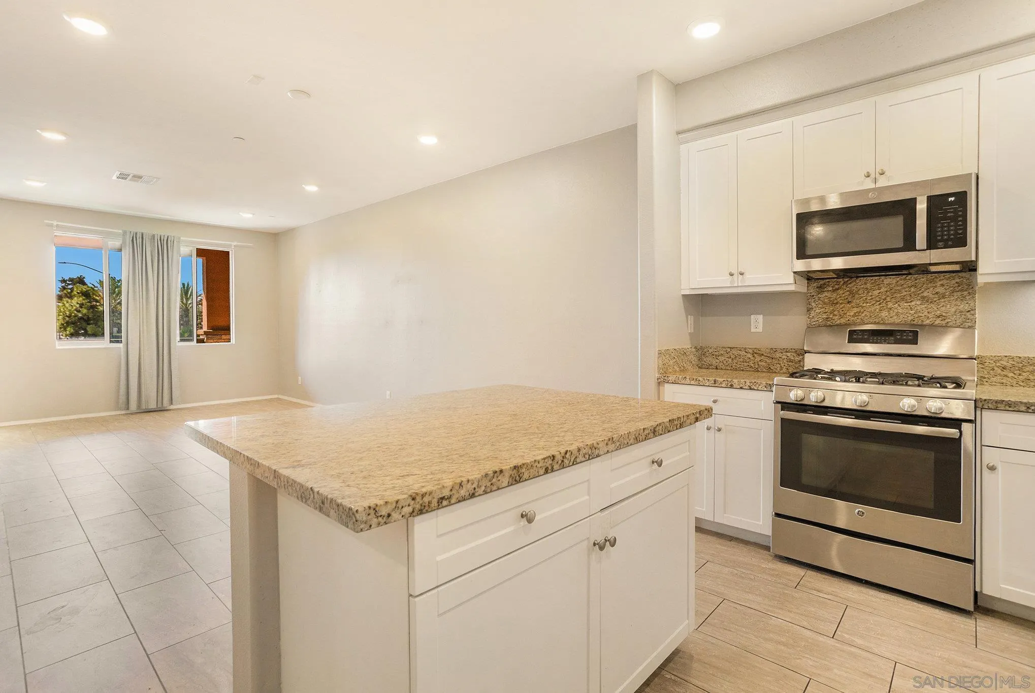 2840 Athens Road, Unit 10 Chula Vista, CA 91915 - Photo 9 of 56 a kitchen with granite countertop white cabinets and stainless steel appliances