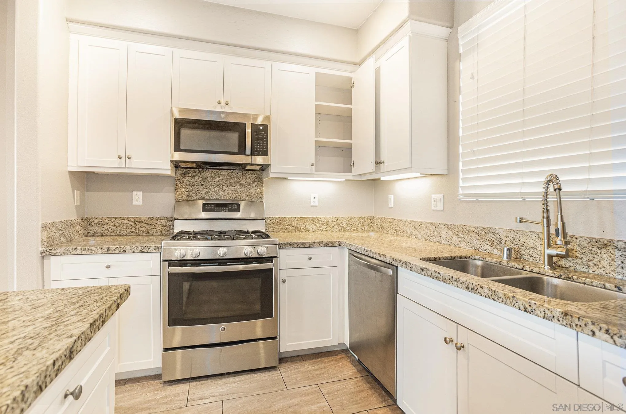 2840 Athens Road, Unit 10 Chula Vista, CA 91915 - Photo 10 of 56 a kitchen with stainless steel appliances granite countertop a sink stove and microwave