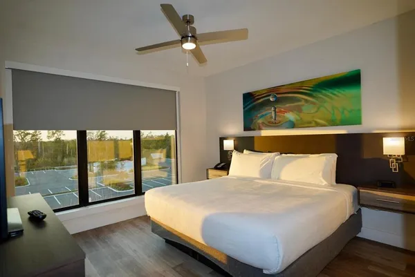 a bedroom with a bed and a mirror