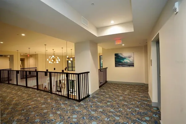 a kitchen with stainless steel appliances wooden floor and chandelier