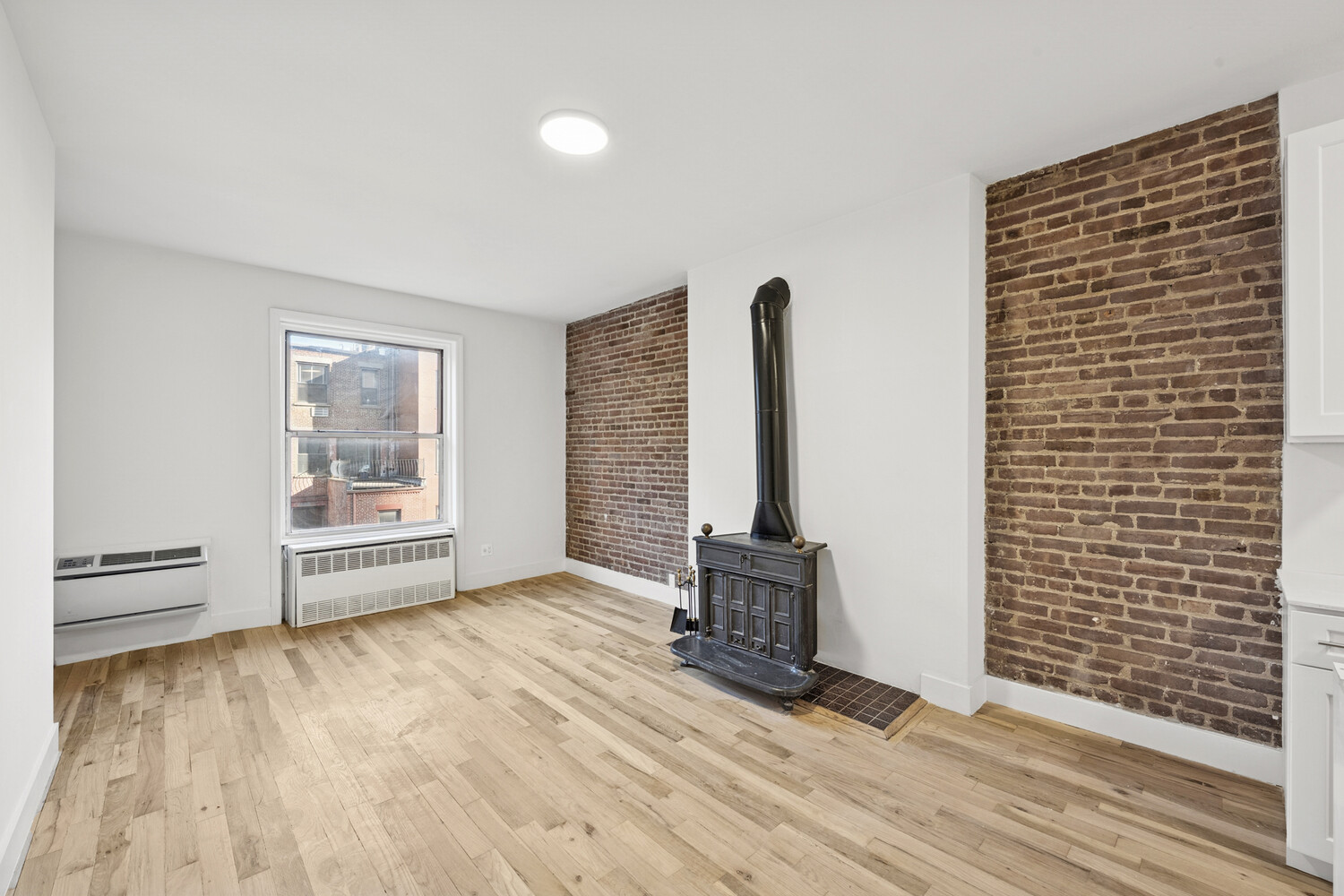 145 West 80th Street, Unit 4R Manhattan, NY 10024 - Photo 2 of 16 a view of an empty room with glass door and wooden floor