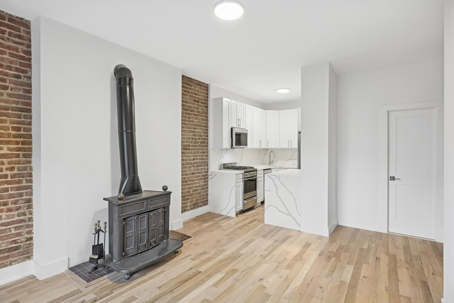 145 West 80th Street, Unit 4R Manhattan, NY 10024 - Photo 5 of 16 a kitchen with a refrigerator and a stove top oven