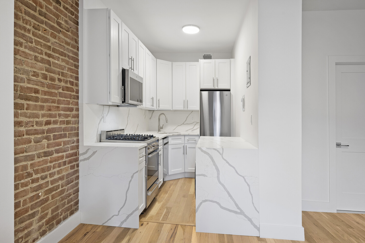 145 West 80th Street, Unit 4R Manhattan, NY 10024 - Photo 6 of 16 a kitchen with stainless steel appliances granite countertop a refrigerator and a stove