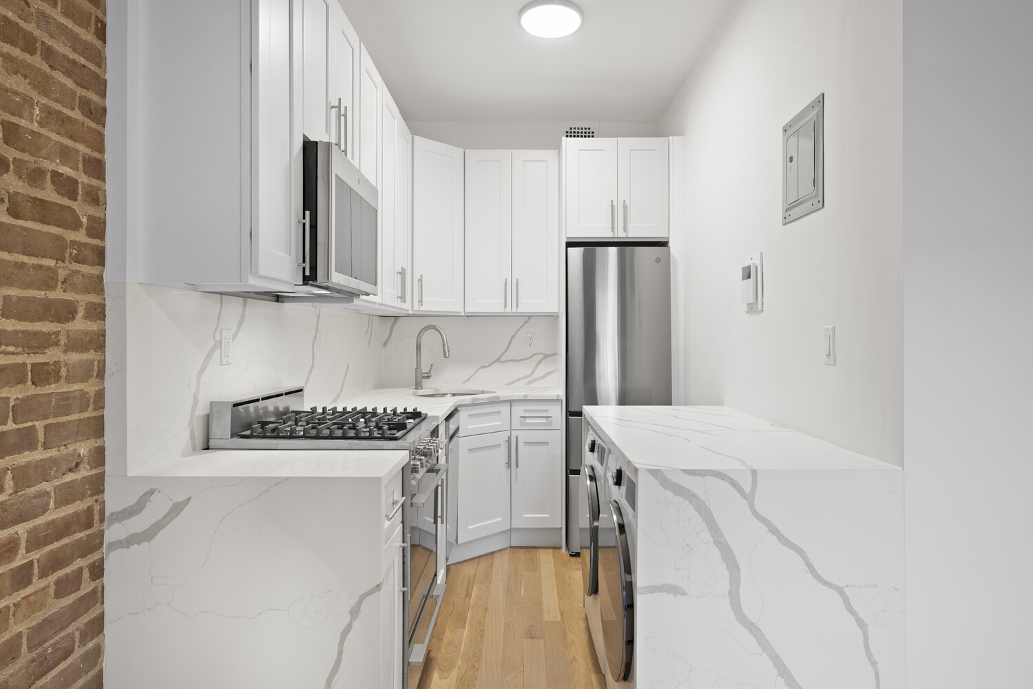 145 West 80th Street, Unit 4R Manhattan, NY 10024 - Photo 7 of 16 a kitchen with a stove a refrigerator and a sink
