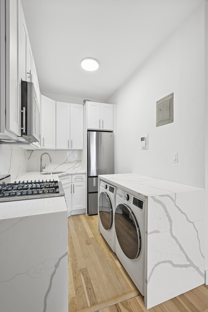 145 West 80th Street, Unit 4R Manhattan, NY 10024 - Photo 8 of 16 a utility room with sink washer and dryer
