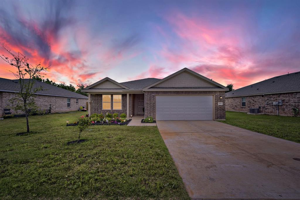 420 Jameson Springtown, TX 76082 - Photo 29 of 29 a front view of a house with a yard and garage