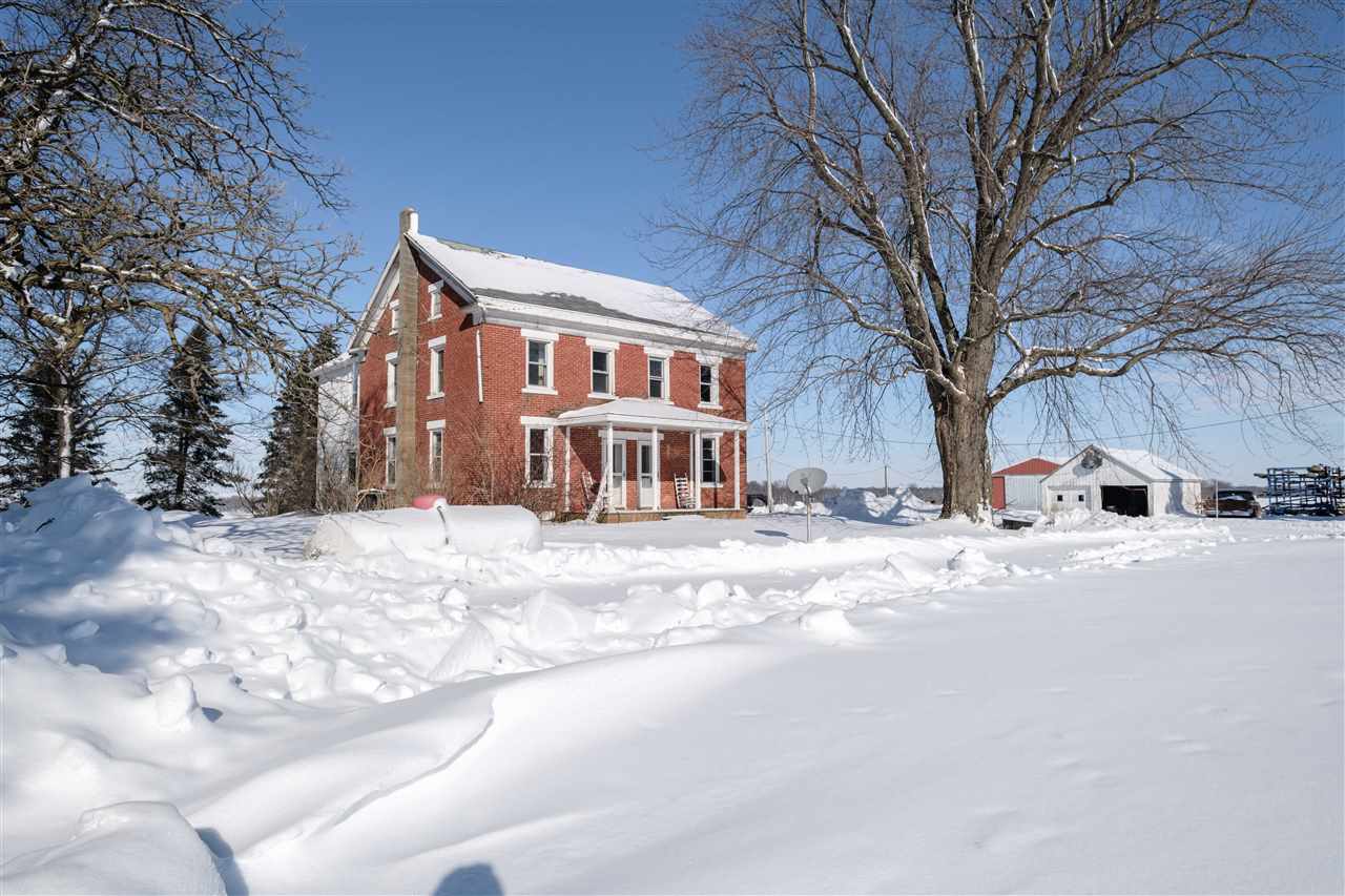 10217 North Adeline Road German Valley, IL 61039 - Photo 4 of 40 a front view of a house with a yard covered in snow