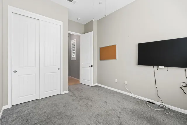 a view of an empty room with flat screen tv