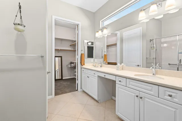 a spacious bathroom with a granite countertop sink mirror and cabinets