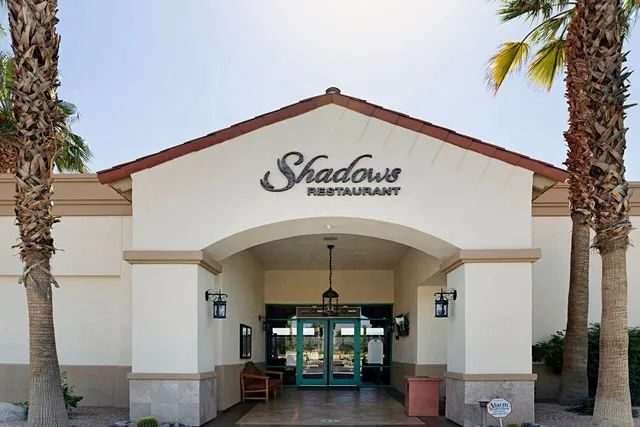 a multi story building with trees in front of it