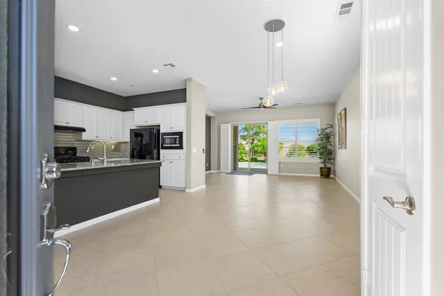 a view of a kitchen with refrigerator and windows