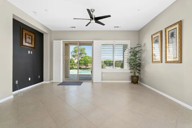 a view of a livingroom with a ceiling fan and window