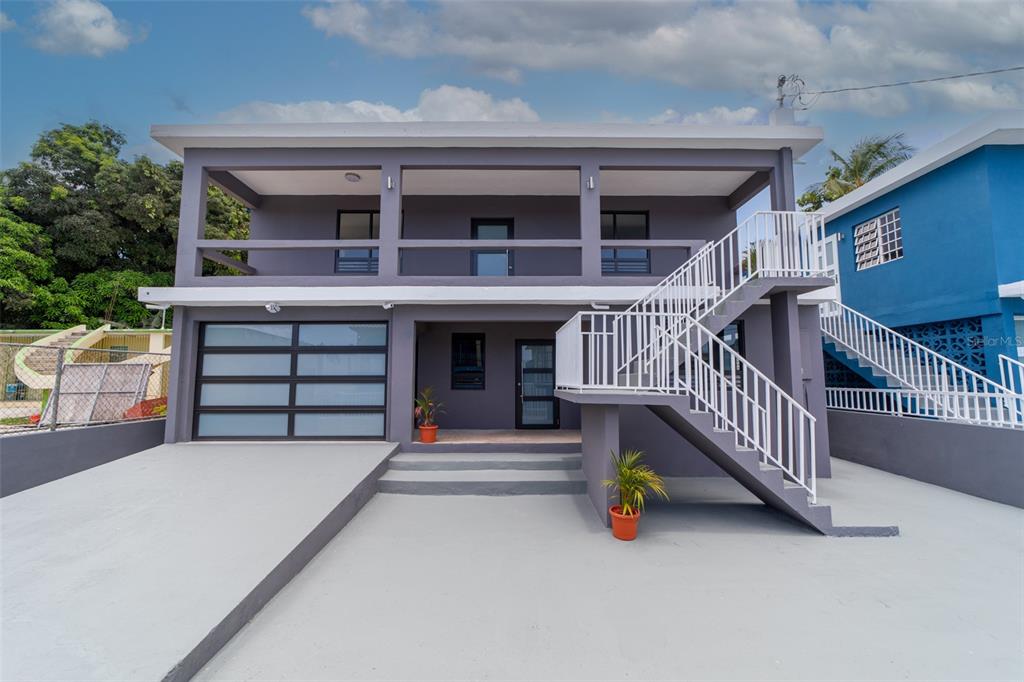 16 Hill Brothers Rio Piedras Prairie, Unit 399A Rio Piedras, PR 00924 - Photo 1 of 1 a view of front door with outdoor seating