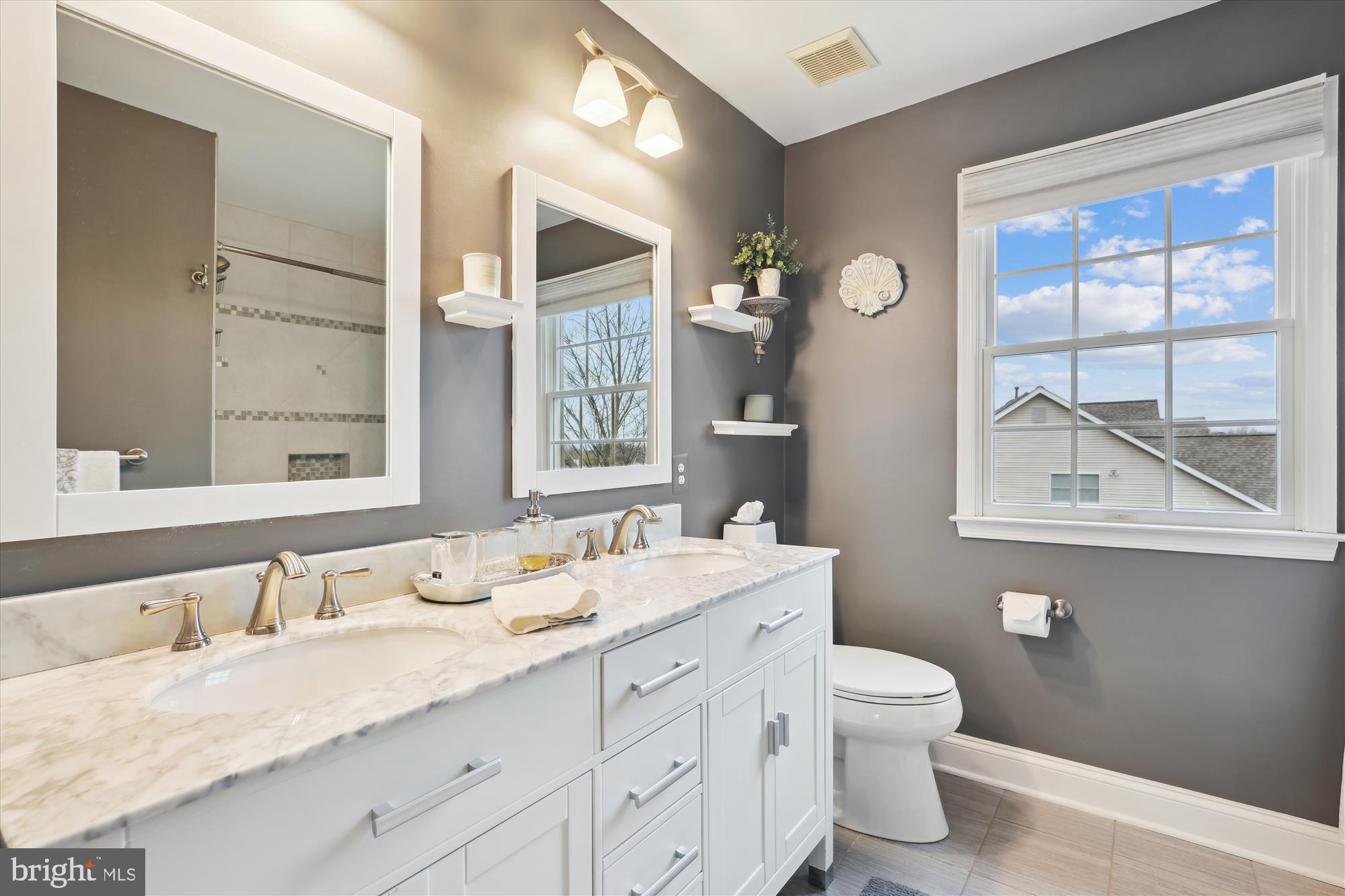 10904 Hunter Gate Way Reston, VA 20194 - Photo 50 of 90 a bathroom with a granite countertop double vanity sink a mirror and a toilet