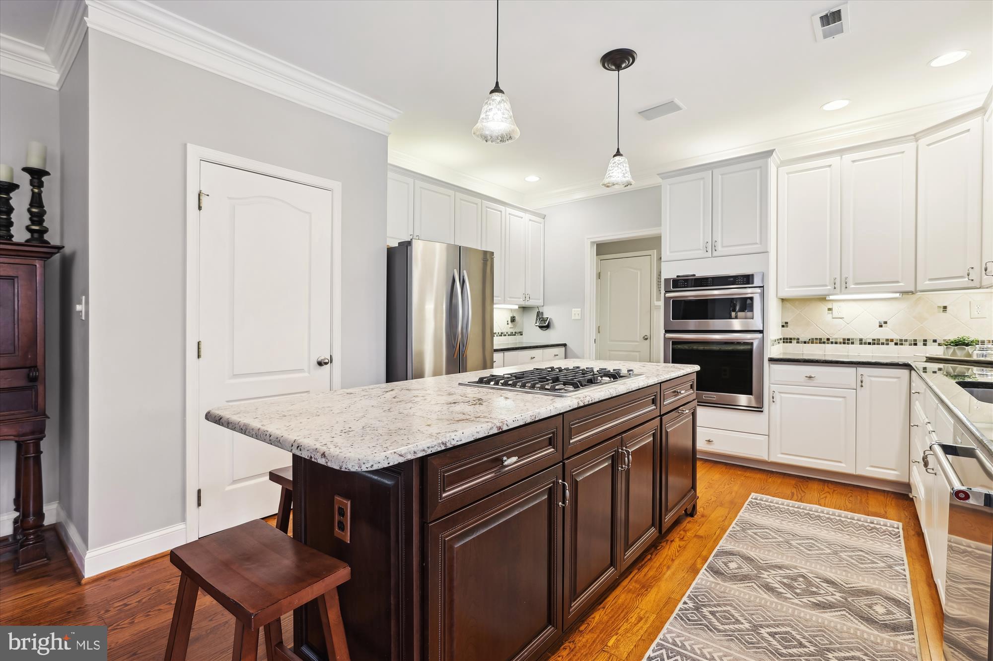 10904 Hunter Gate Way Reston, VA 20194 - Photo 6 of 90 a kitchen with stainless steel appliances granite countertop a stove top oven a refrigerator a sink and dishwasher with wooden floor