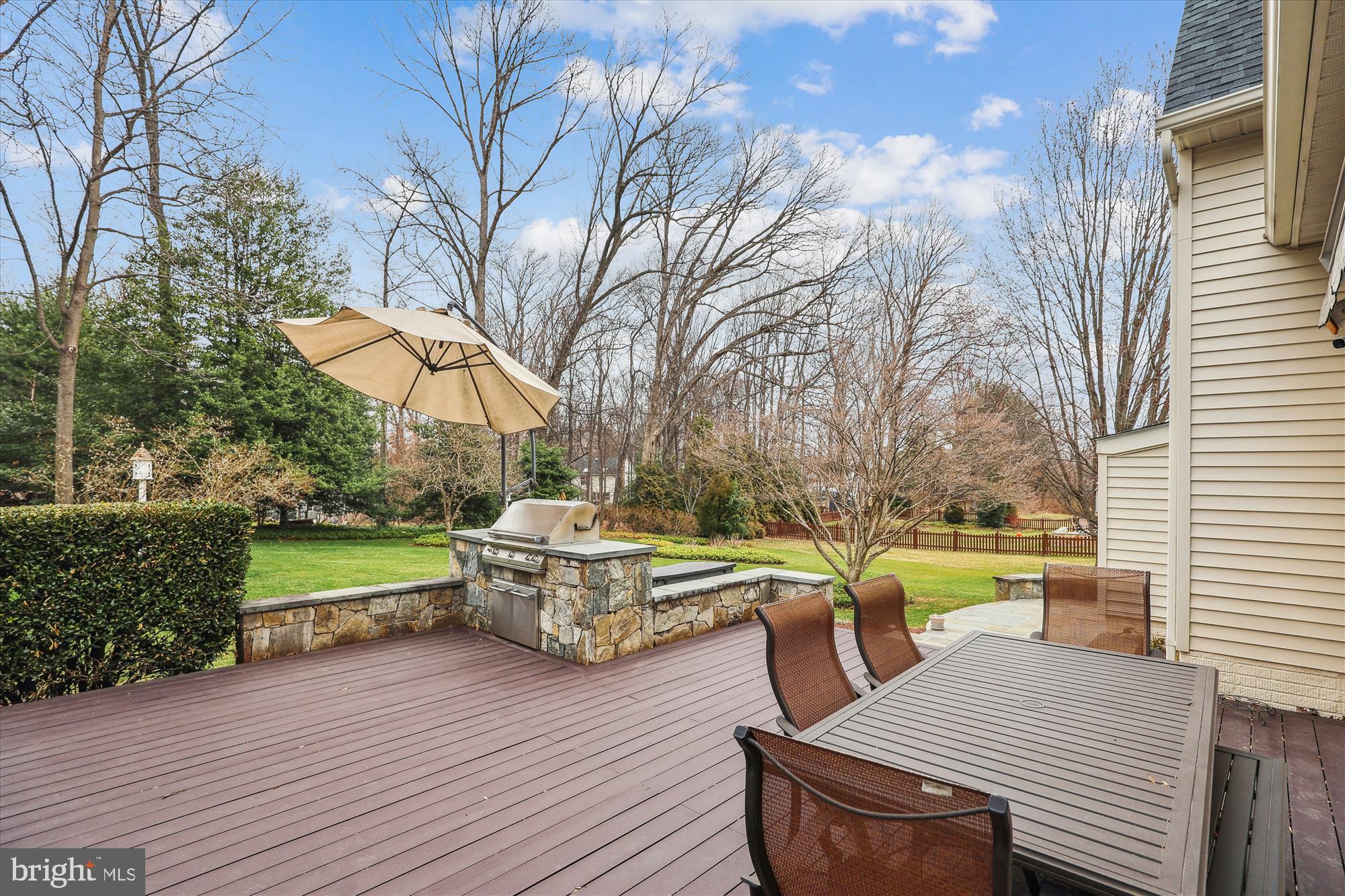 10904 Hunter Gate Way Reston, VA 20194 - Photo 72 of 90 a view of a roof deck with table and chairs a barbeque with wooden floor and fence