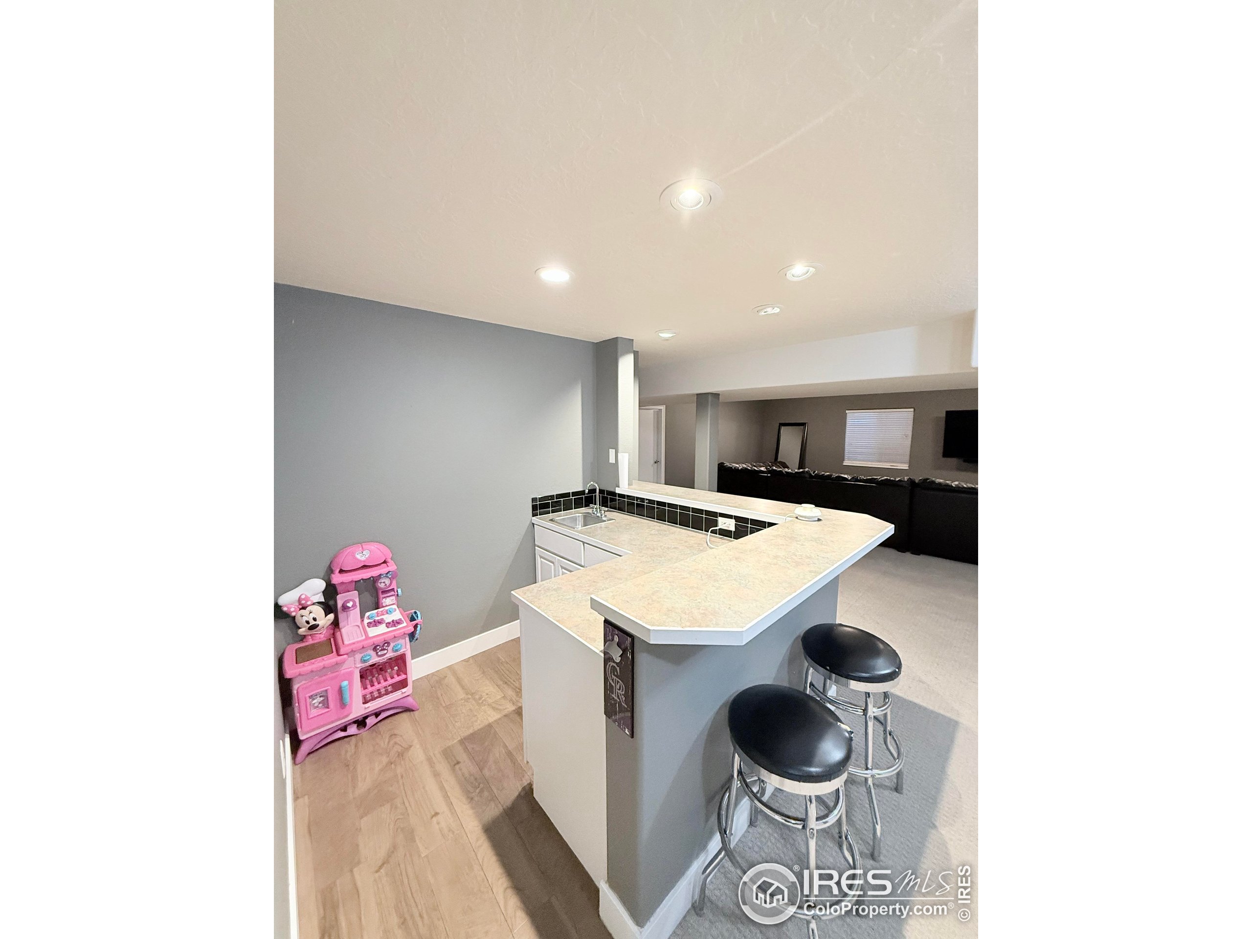 1460 Hawkridge Road Eaton, CO 80615 - Photo 17 of 20 a kitchen with a sink and a stove with white cabinetry