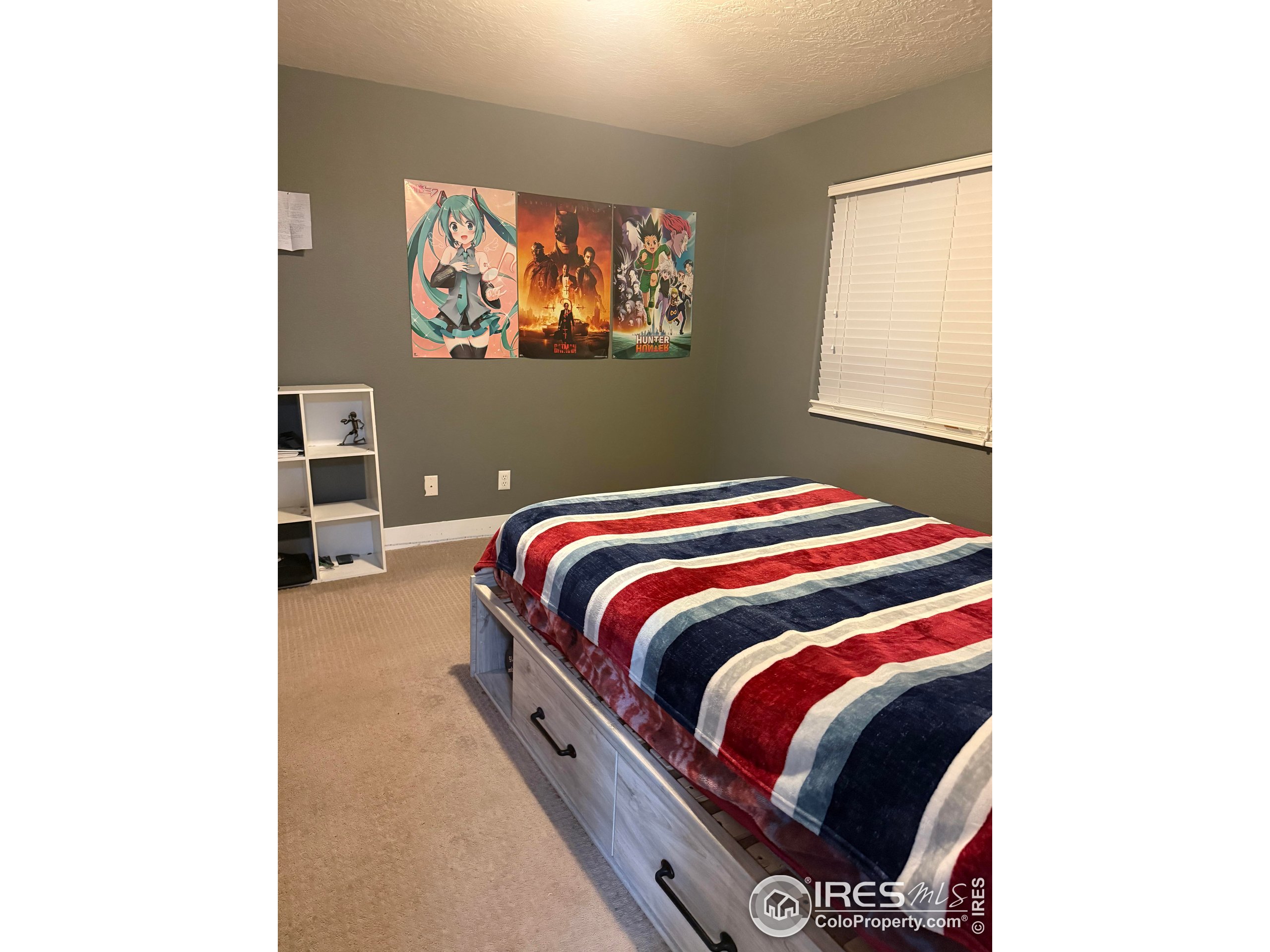 1460 Hawkridge Road Eaton, CO 80615 - Photo 19 of 20 a bedroom with a bed and a painting on the wall