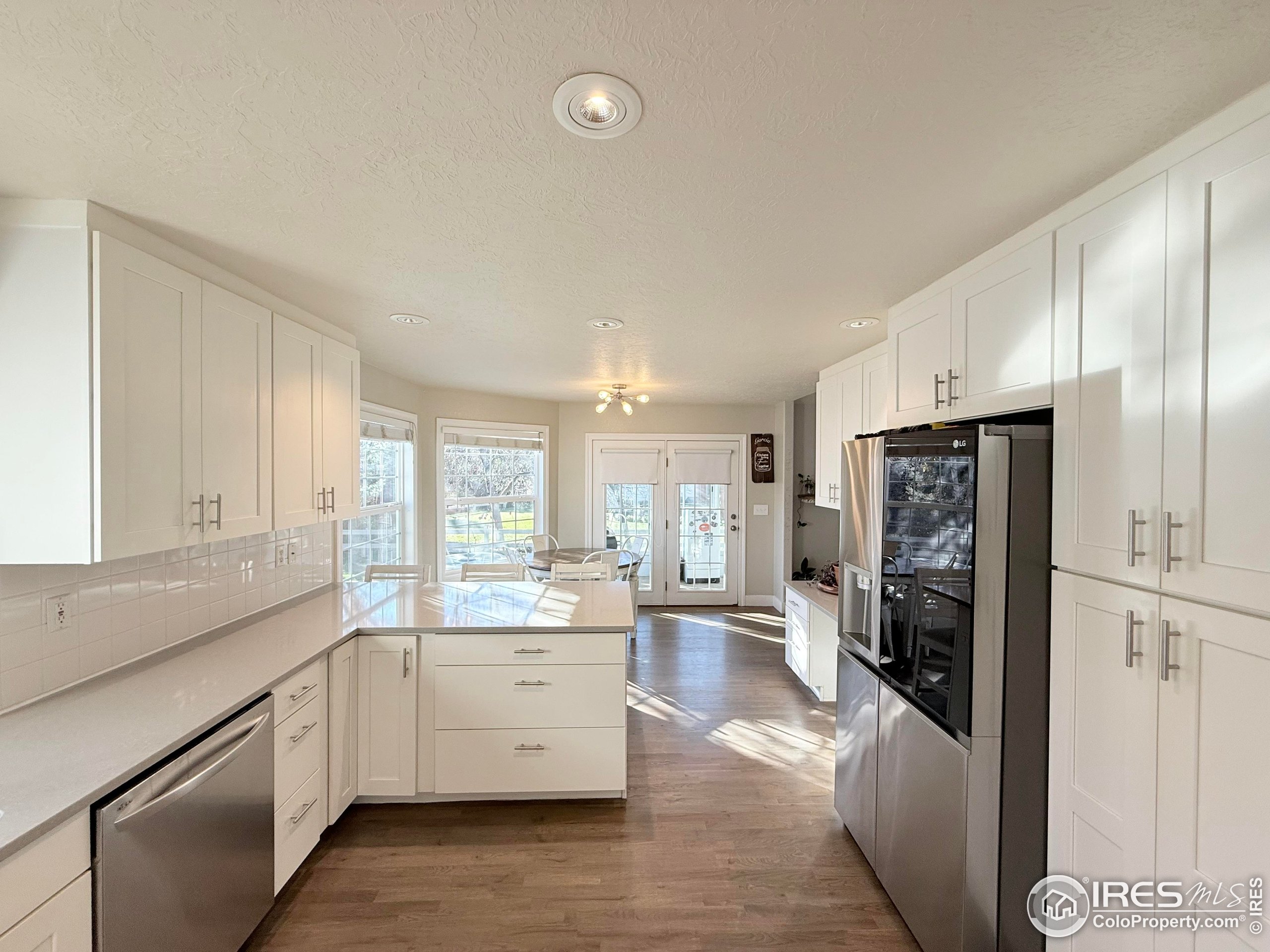 1460 Hawkridge Road Eaton, CO 80615 - Photo 6 of 20 a kitchen with stainless steel appliances a refrigerator sink and cabinets