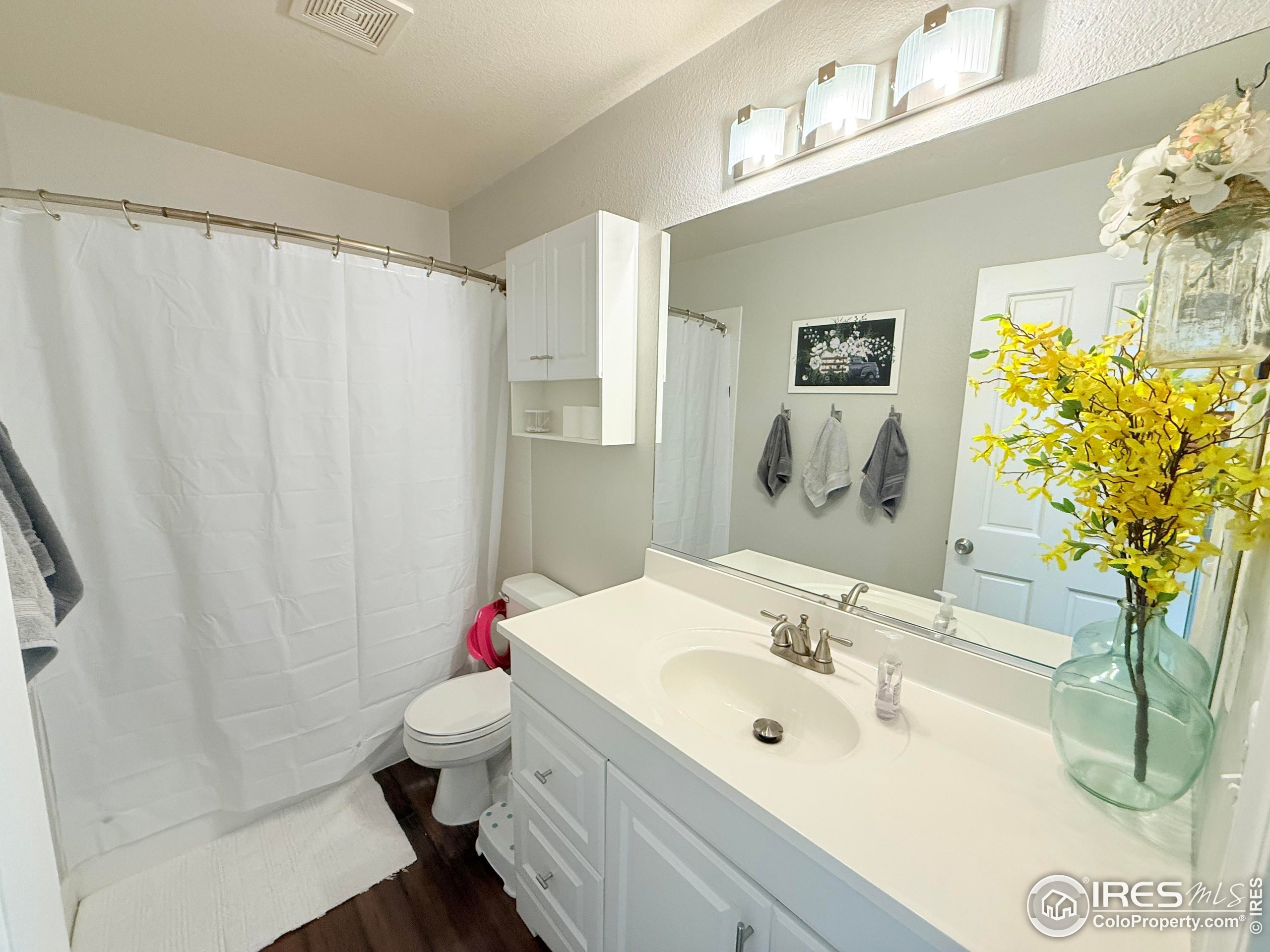 1460 Hawkridge Road Eaton, CO 80615 - Photo 10 of 20 a bathroom with a sink a mirror and a toilet