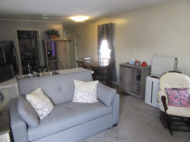 3251 E Road, Unit 99 Clifton, CO 81520 - Photo 13 of 25 a living room with furniture and a window