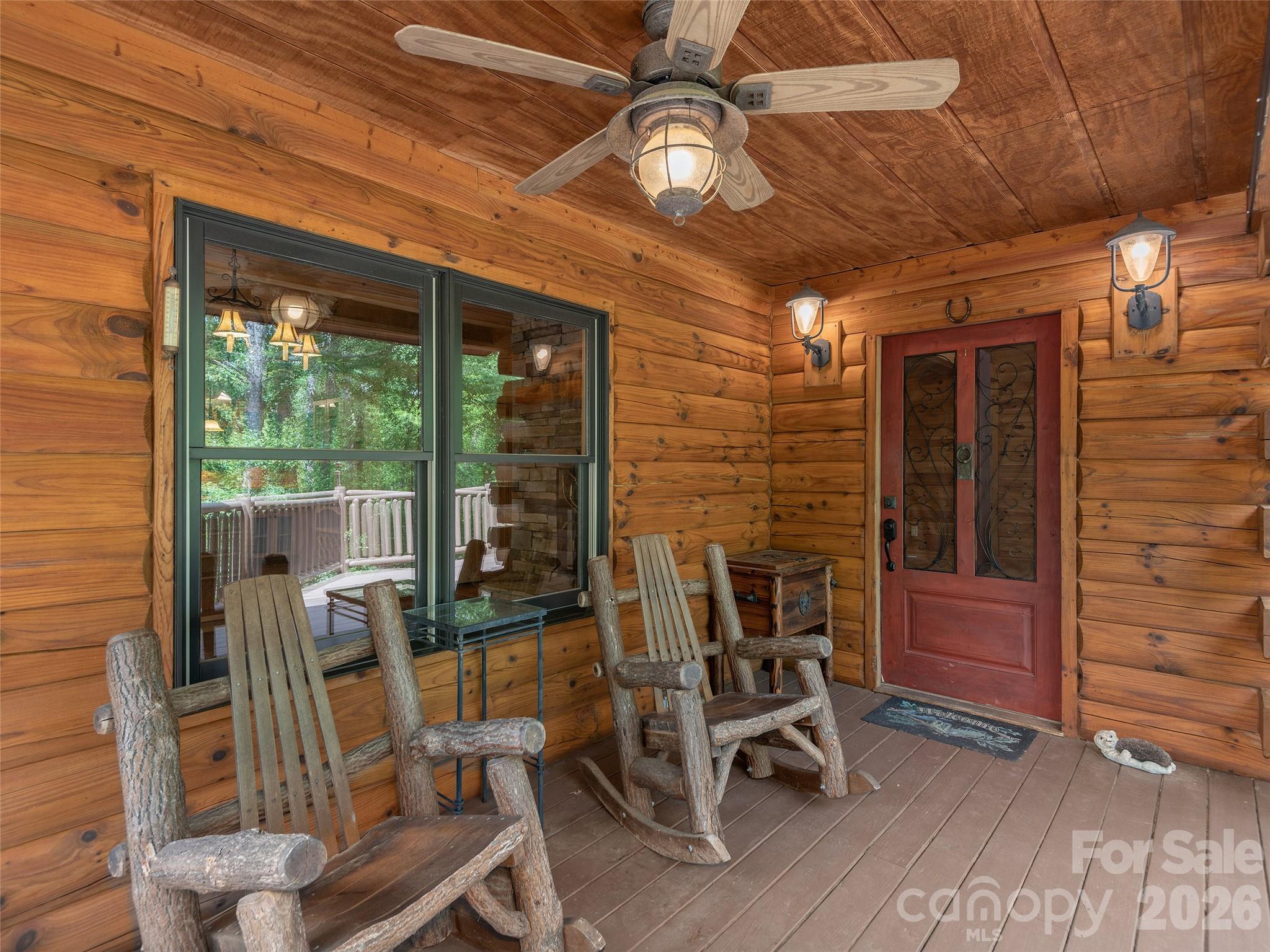 413 Green Hills Road Mill Spring, NC 28756 - Photo 5 of 48 a view of a room with wooden furniture and windows