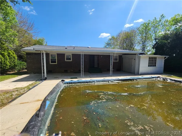 a view of a house with swimming pool and porch