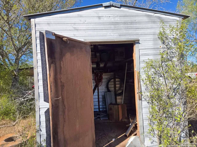 a front view of a house with glass windows and garden
