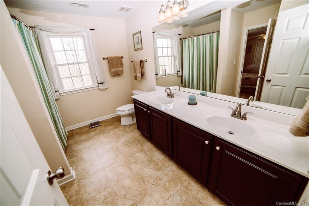 522 Zackery Lane Fort Mill, SC 29708 - Photo 14 of 24 a spacious bathroom with a double vanity sink a mirror and a bathtub
