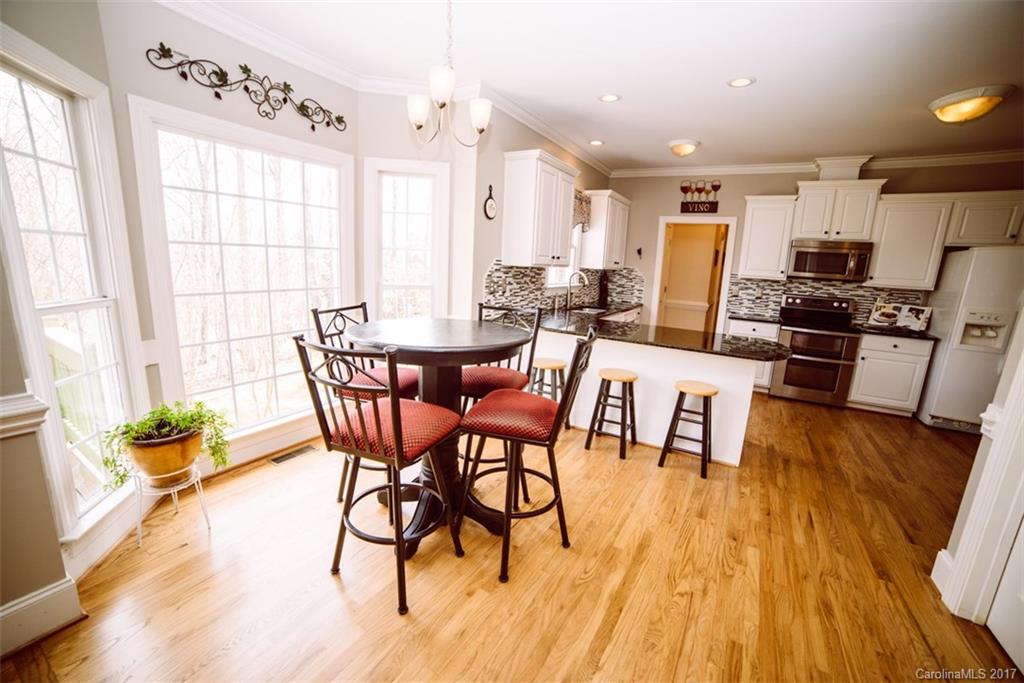 522 Zackery Lane Fort Mill, SC 29708 - Photo 7 of 24 a view of a dining room with furniture and wooden floor