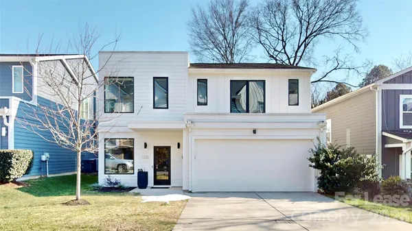 a view of a white house with a outdoor space