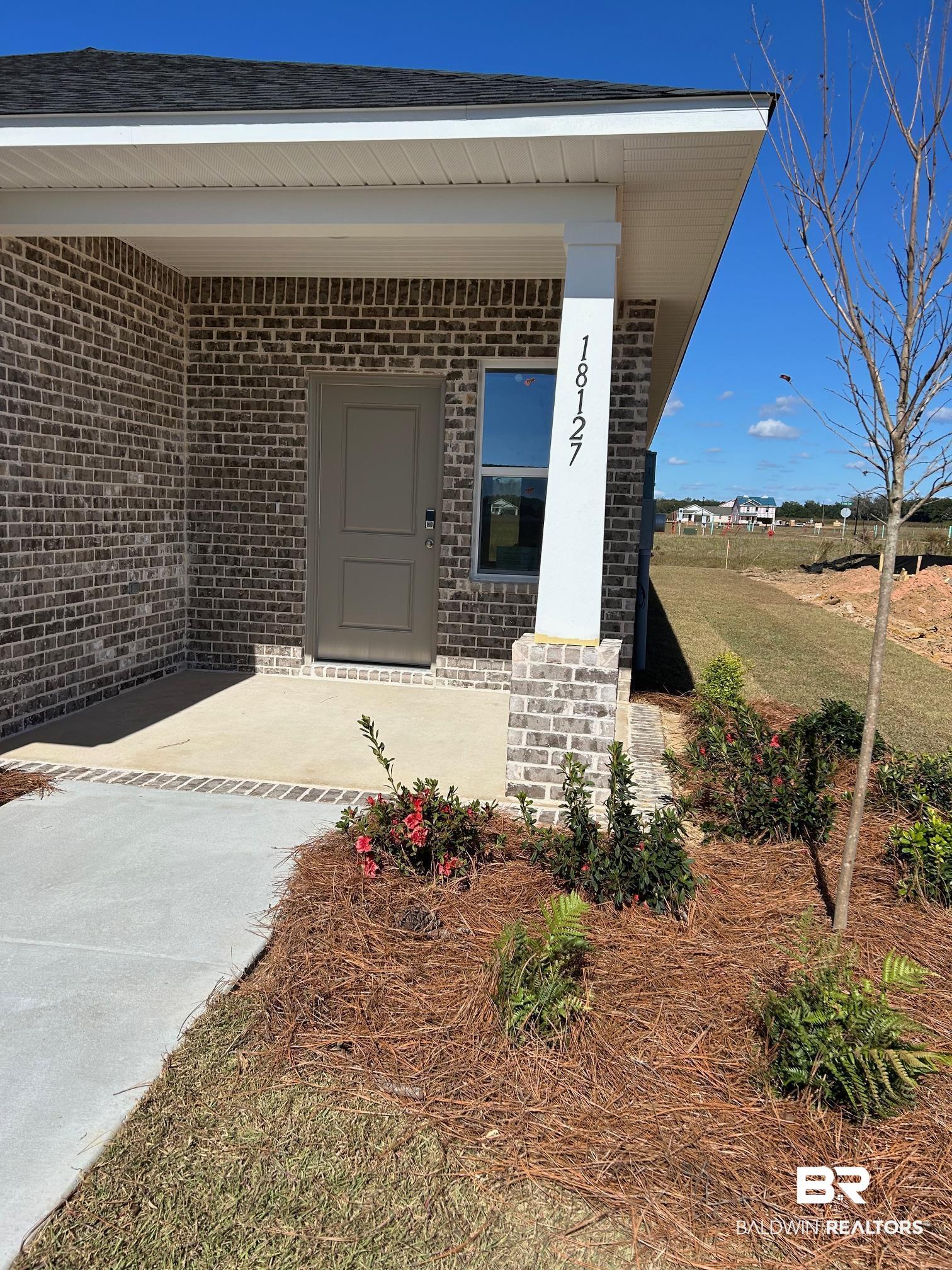 18127 Kent Circle Foley, AL 36535 - Photo 2 of 8 Entrance to property with brick siding and a porch