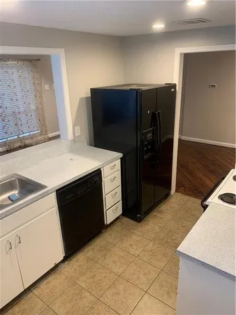 a kitchen with a refrigerator and a sink