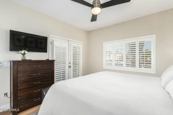 a bedroom with a bed and a flat screen tv