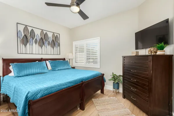 a bedroom with a bed and a flat screen tv