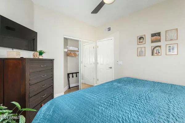 a bedroom with a bed and a flat screen tv