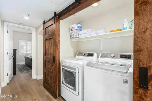 a view of washer and dryer with kitchen in the background