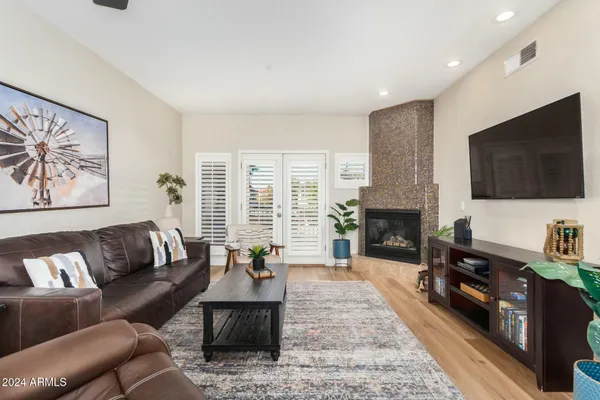 a living room with furniture fireplace and flat screen tv