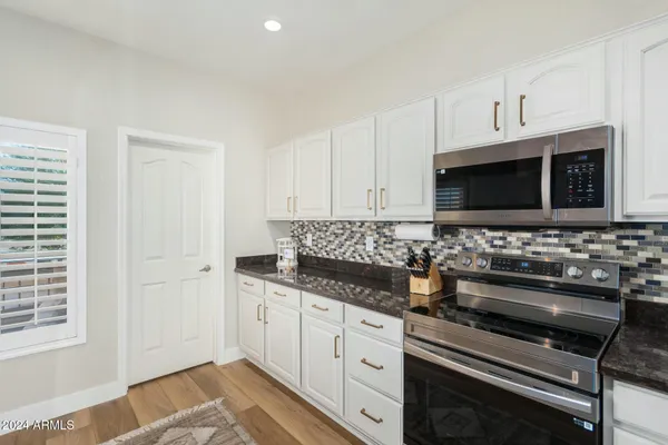 a kitchen with stainless steel appliances a stove a microwave and sink