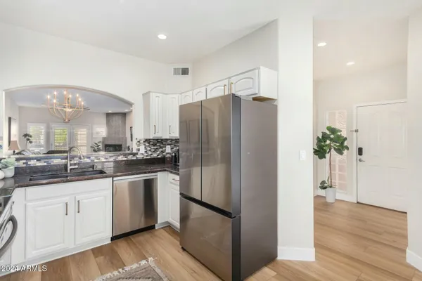 a kitchen with stainless steel appliances a refrigerator and a sink