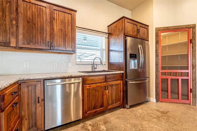 a view of a kitchen with furniture and windows