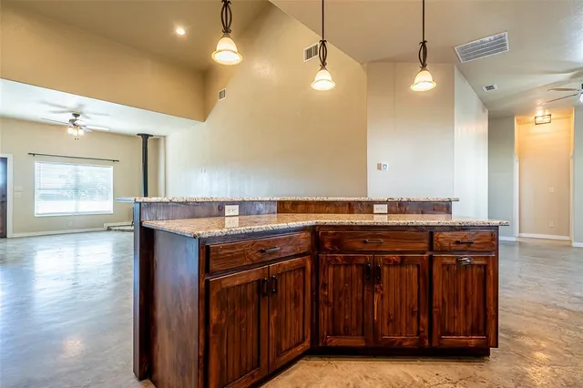 a kitchen with cabinets and stainless steel appliances