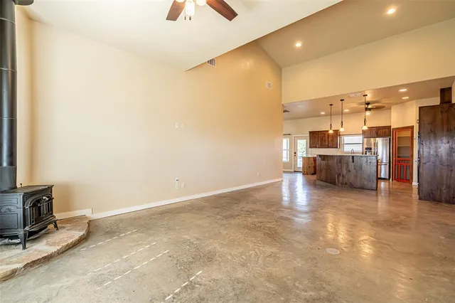 a view of a hallway with wooden floor and a bathroom