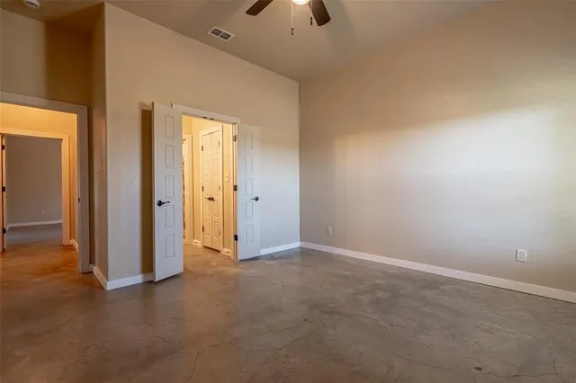 an empty room with a empty space and a ceiling fan